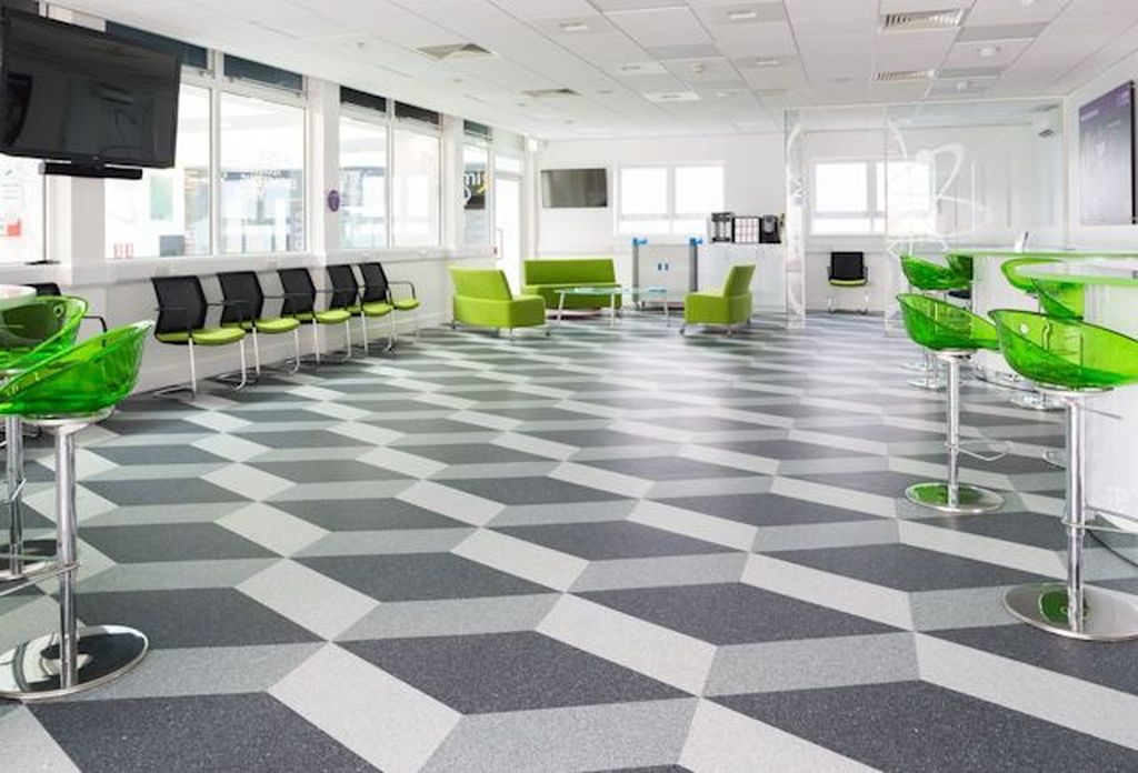 Commercial flooring - an image of a flooring solution that is in a work based canteen are, using a very distinctive and bold design and colours